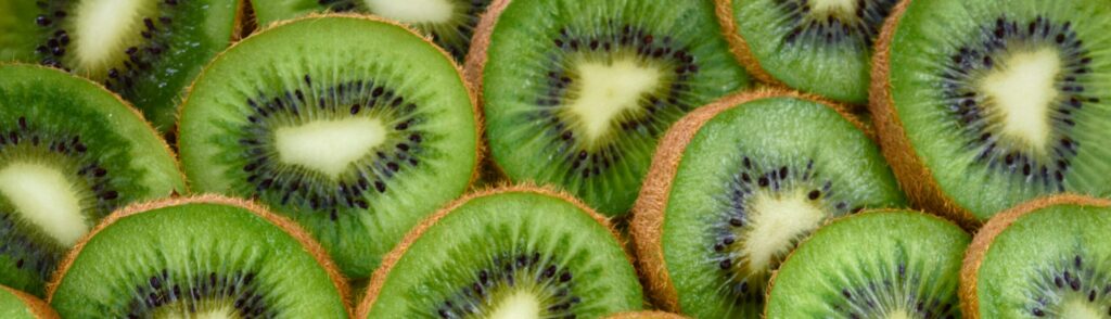 Vibrant, fresh kiwi slices arranged close-up, highlighting their juicy and nutritious appeal.