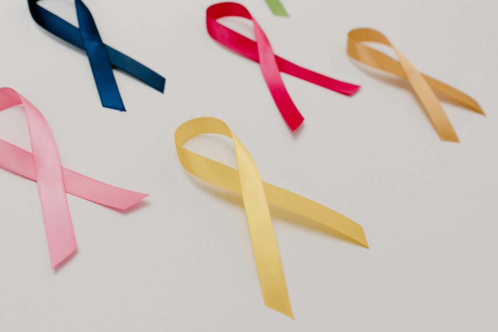 A collection of colorful awareness ribbons symbolizing various causes on a white surface.